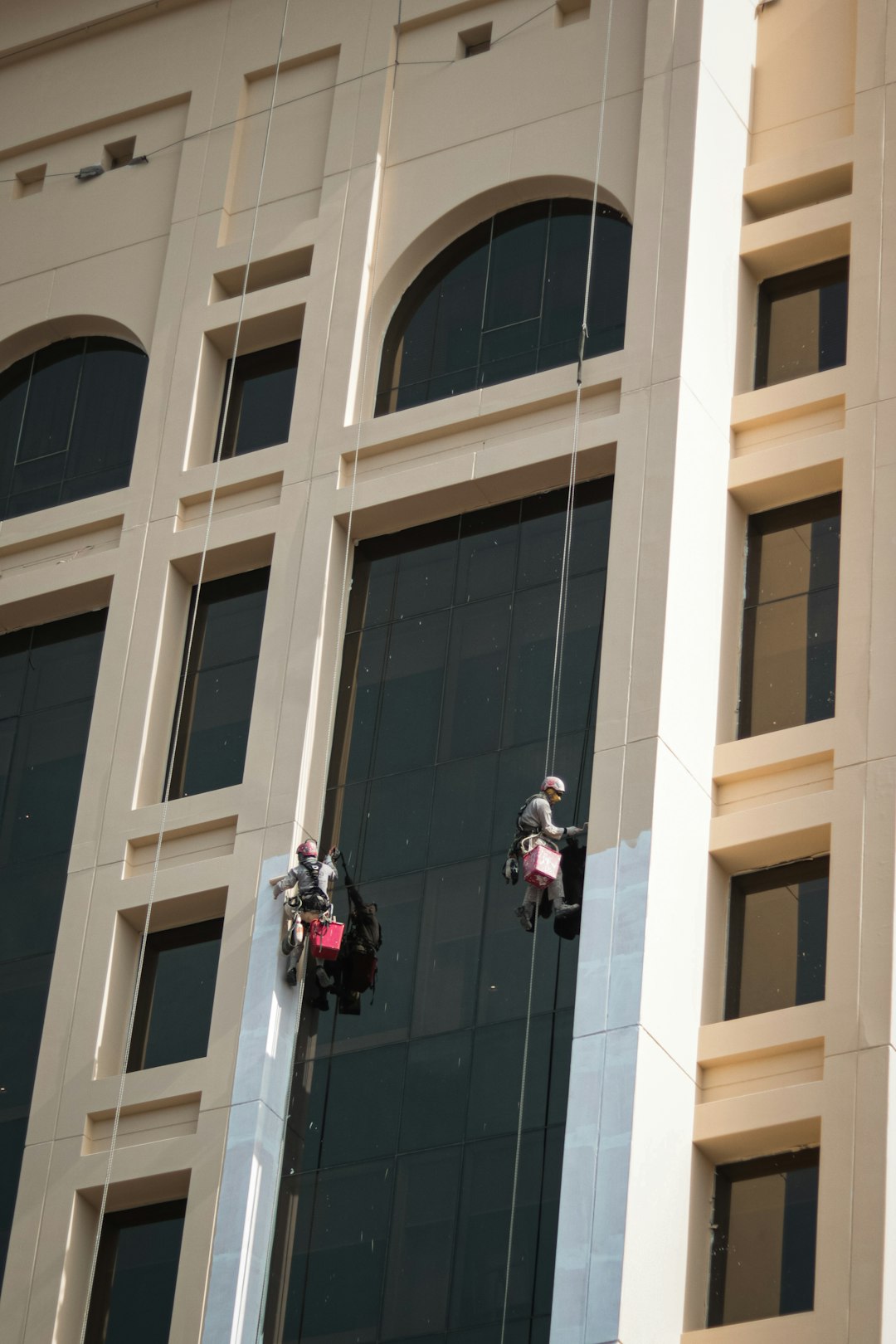 Professional cleaner working on a modern office building in Dubai