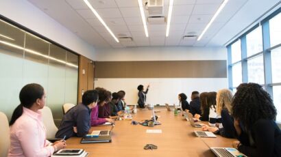 Business professionals discussing workforce management and employer of record services in a modern office