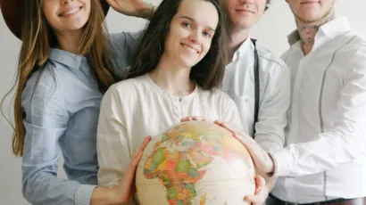 International team holding a globe, representing workforce growth in the UAE